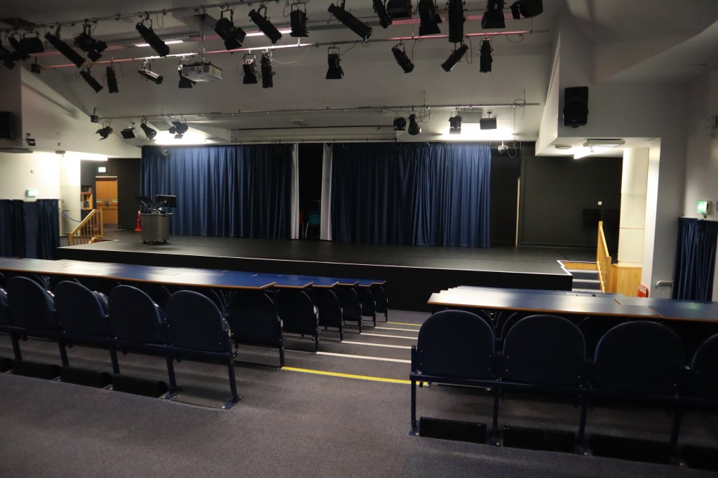 A picture of the theatre from the middle row. The entire stage is in view. 